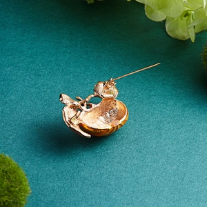 Detailed back view of pumpkin brooch showing the metal pin and secure safety clasp