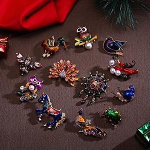 Detail of colorful enamel brooches with rhinestones and pearls on a festive background