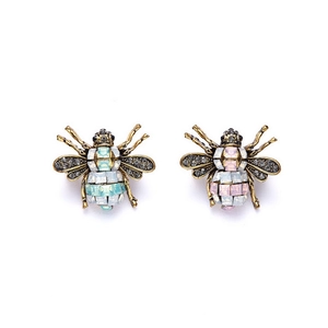 Detail of vintage gold bee earrings featuring blue and purple crystals and rhinestones