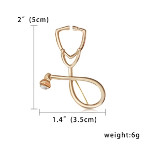 Detailed size view of a gold stethoscope brooch with dimensions and crystal detail