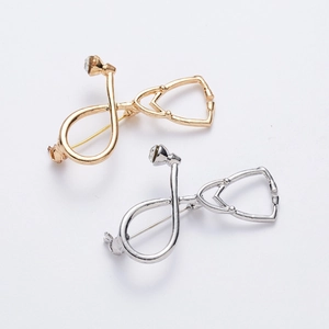 Creative stethoscope brooches in gold and silver alloy finish with sparkling rhinestones