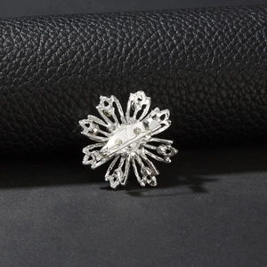 Vista dettagliata del retro della spilla a fiore argento con chiusura a spilla di sicurezza