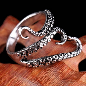 Detailed close-up of octopus tentacle ring with vintage silver finish and sucker texture