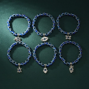 Set of 6 blue evil eye beaded bracelets with silver elephant, butterfly and owl charms
