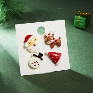 Detailed view of 4-piece Christmas earring set with Santa and snowman on display card