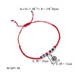 Detailed view of red woven Evil Eye bracelet with silver rose pendant and size markings