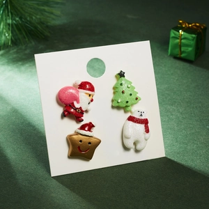 Detailed view of 4-piece Christmas brooch set with Santa, tree, star and polar bear