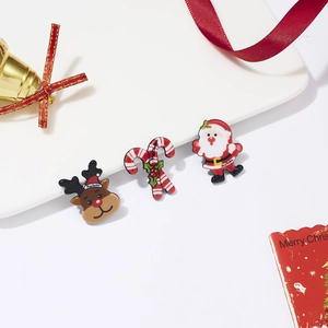 Detailed close-up of Christmas brooch set featuring reindeer and Santa on a white tray