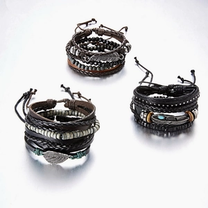 Detail of adjustable leather bracelets with feather pendant and multi-layer wood beads