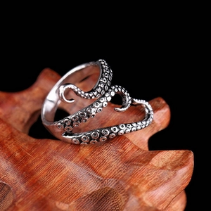 Macro shot of vintage octopus tentacle ring with detailed suction cups on wood base