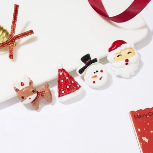Detailed view of resin Christmas badges with reindeer, snowman and Santa motifs and glitter