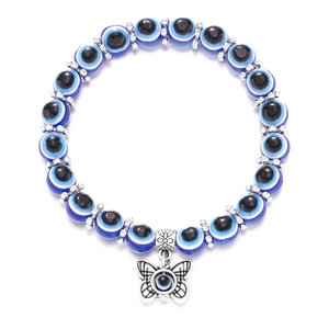 Macro view of blue evil eye beads with silver flower spacers and a butterfly charm pendant