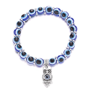 Detailed close-up of blue Evil Eye beaded bracelet featuring a silver owl charm pendant