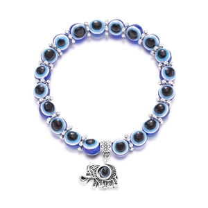 Macro shot of blue Evil Eye beads and elephant charm bracelet with silver-tone spacers