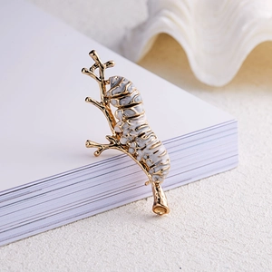 Exquisite gold-plated caterpillar on branch brooch with elegant marble enamel details