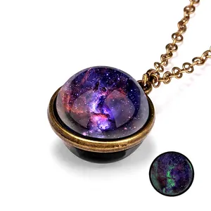 Detail of vintage galaxy pendant with nebula pattern showing green luminous glow effect