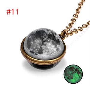 Macro detail of bronze galaxy necklace with luminous moon pendant and glowing effect