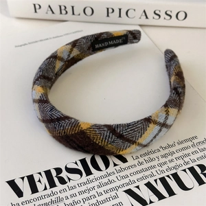 Detail of vintage plaid scrunchie with handmade label on classic artistic background
