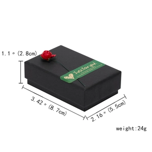Close-up of black jewelry gift box with red rose decoration and Just for you label
