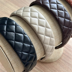 Close-up of diamond-quilted leather headbands in black, beige, and dark brown colors