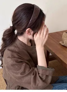 Close-up of vintage brown quilted leather headband worn by a model with a retro style