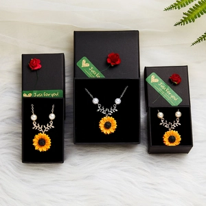 Sunflower necklace with pearls in a black gift box decorated with a red rose