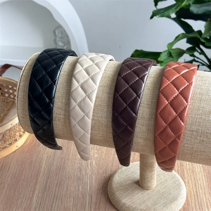 Detail view of quilted PU leather headbands in black beige brown and brick red colors