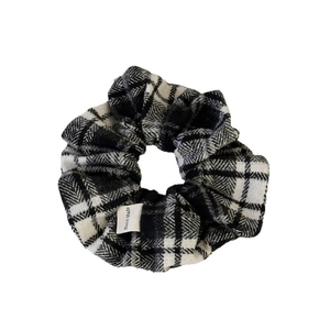 Classic black and white checkered scrunchie with handmade label on white background