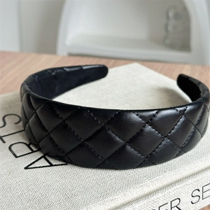 Detailed close-up showing the black quilted leather texture and stitching of the headband
