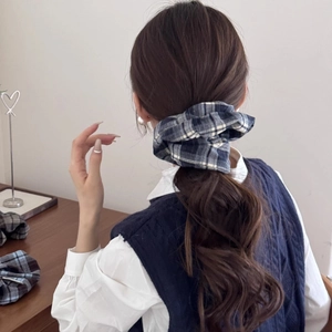 Classic blue and white plaid scrunchie shown on a ponytail with premium fabric texture