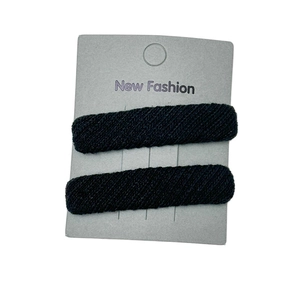 Set of two black twill fabric rectangle hair clips for women on a display card
