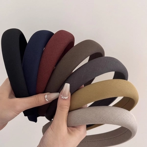 Detail showing various colors of thick sponge headbands with knitted fabric texture