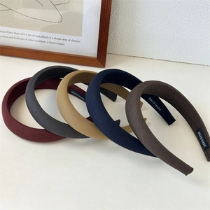 Five solid color padded sponge headbands with cotton linen texture and handmade label