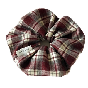 Classic red plaid scrunchie with handmade tag showing a vintage academic style look