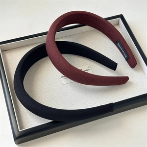 Detail of handmade padded headbands in black and burgundy with fine twill fabric texture