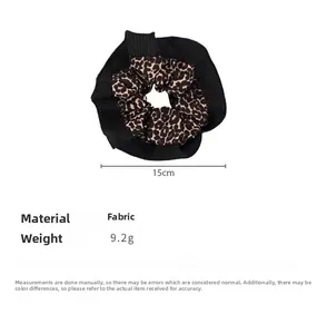 Detail view of leopard print scrunchie showing 15cm diameter size and 9.2g weight