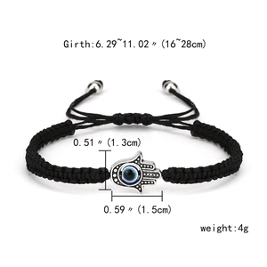 Detail shot showing Hamsa Hand pendant dimensions on black woven Evil Eye bracelet