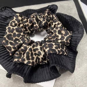 Leopard print satin scrunchie with black pleated edges for a stylish women hair look