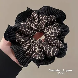 Detail of a 15cm oversized leopard print scrunchie with elegant black pleated lace edging