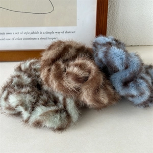 Plush zebra pattern hair scrunchies in soft green, brown, and blue for bun hairstyles