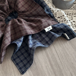 Retro brown plaid fabric scrunchie with vintage pattern and minimalist brand label