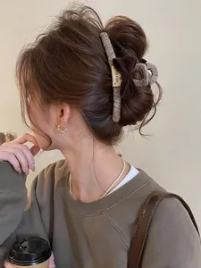 Detail of vintage brown velvet bow hair claw clip with Sweet Life label on hair