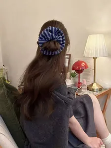 Blue-grey striped knit scrunchie shown in a back-view hairstyle for autumn/winter