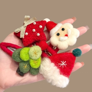 Detail of wool felt Christmas hairpins set with pearls and festive embroidery