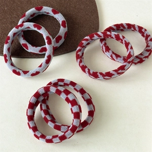 Detailed view of elastic knit hair ties featuring heart, stripe and checker patterns