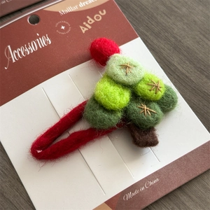 Handmade wool felt Christmas tree hair clip for girls with a festive star pattern