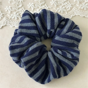 Knitted striped scrunchie in navy blue and grey wool for autumn winter hairstyles