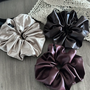 Set of three premium satin scrunchies in champagne, chocolate brown, and burgundy