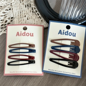 Set of 4 vintage water drop hair clips in dark colors on display card for women