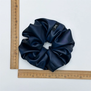 Thick navy blue satin scrunchie with metallic sheen, 12cm diameter shown on ruler